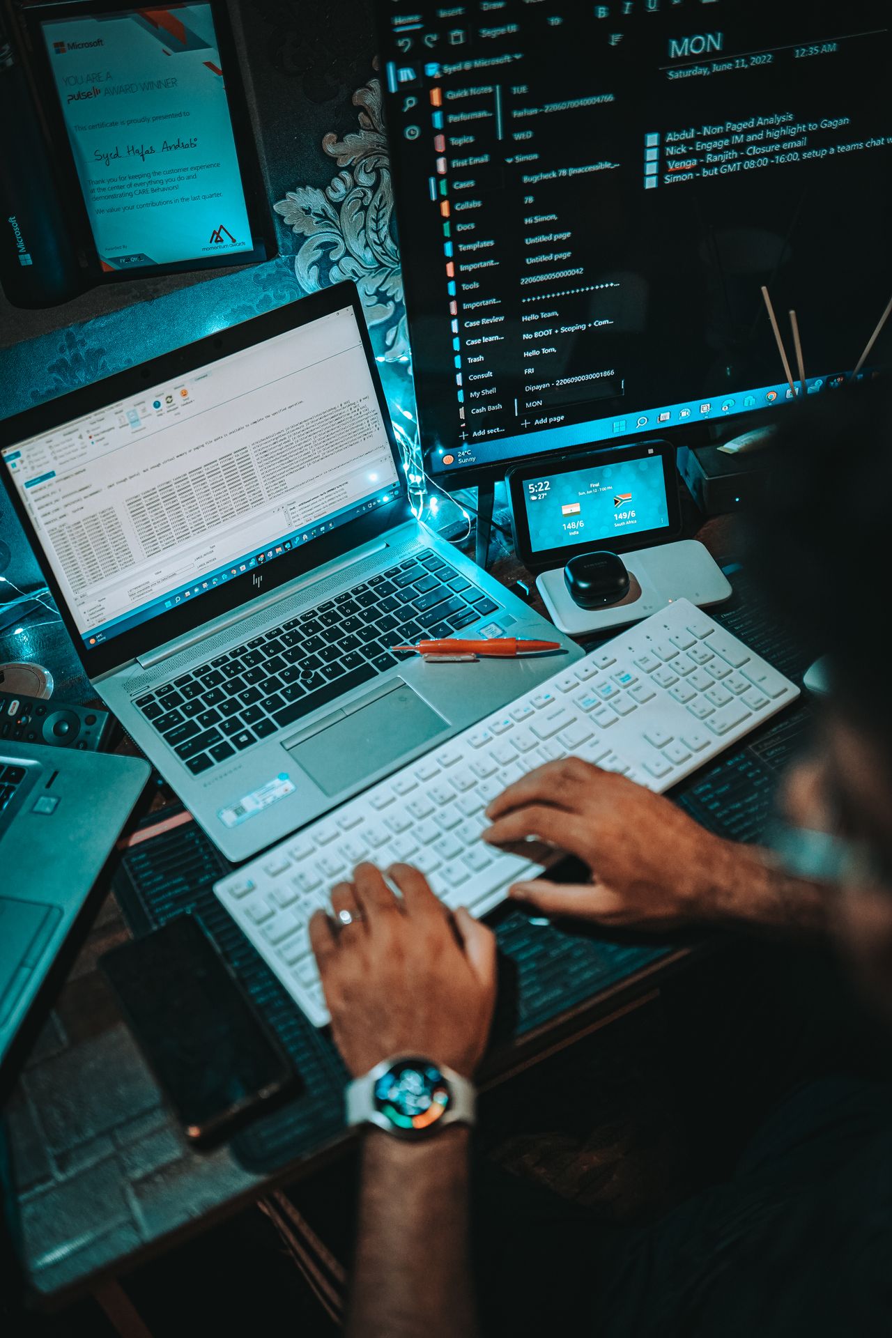 IT professional at a desk with multiple monitors